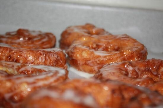 Dip crullers into the glaze and set them onto a wire rack to dry French Crullers with Honey Glaze